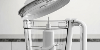 food processor with clear bowl and white lid sitting on gran 20260527 065723